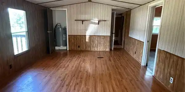 Image 3: Spacious interior featuring wood-finish flooring,