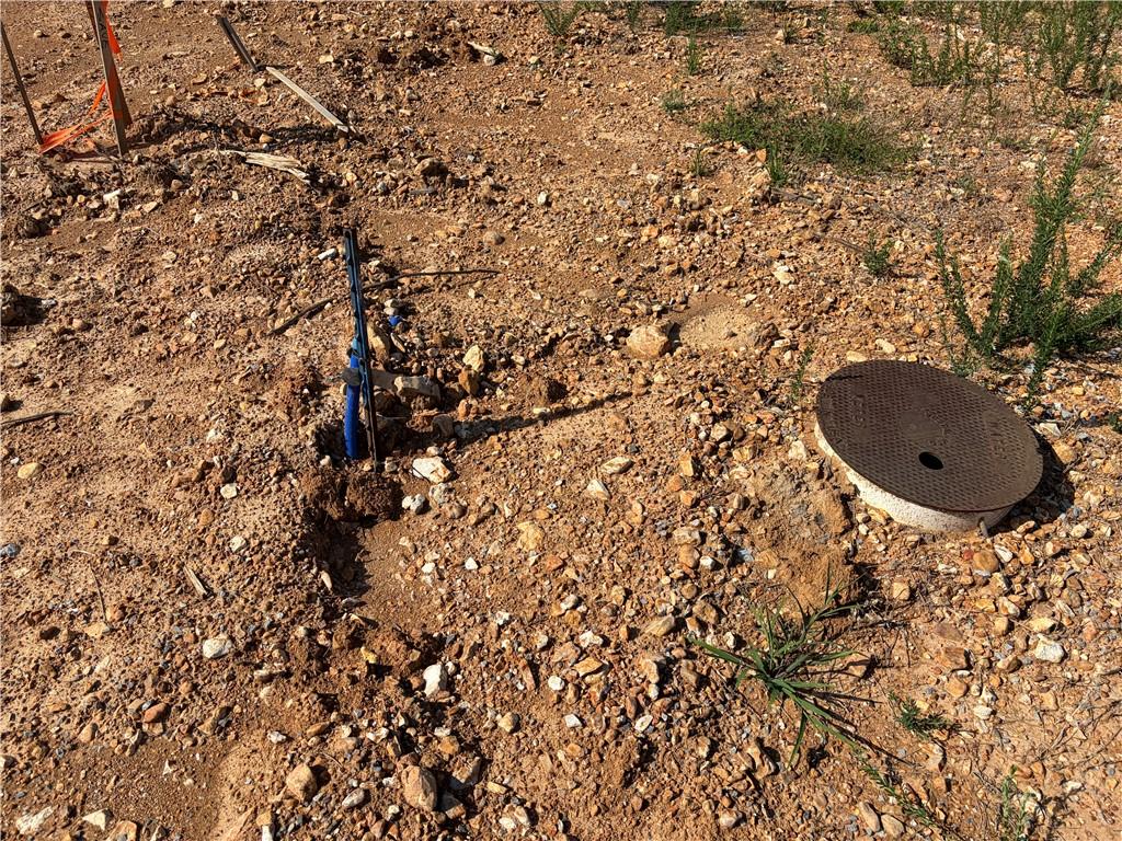 Image 4: Utility access points visible on a raw land parcel