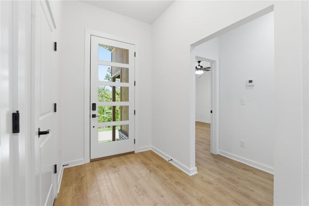 Image 2: Entryway featuring a modern five-panel glass door