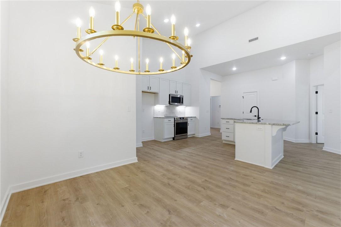 Image 4: Spacious interior featuring a large gold chandelie