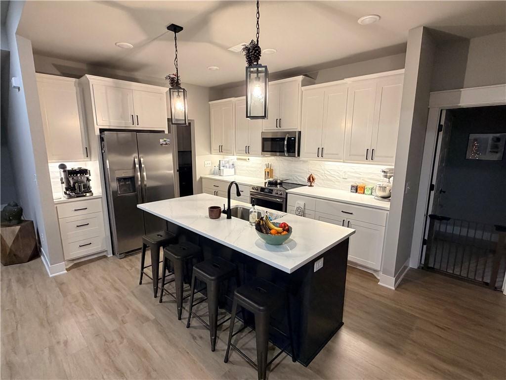 Image 3: Kitchen featuring stainless steel appliances, a br