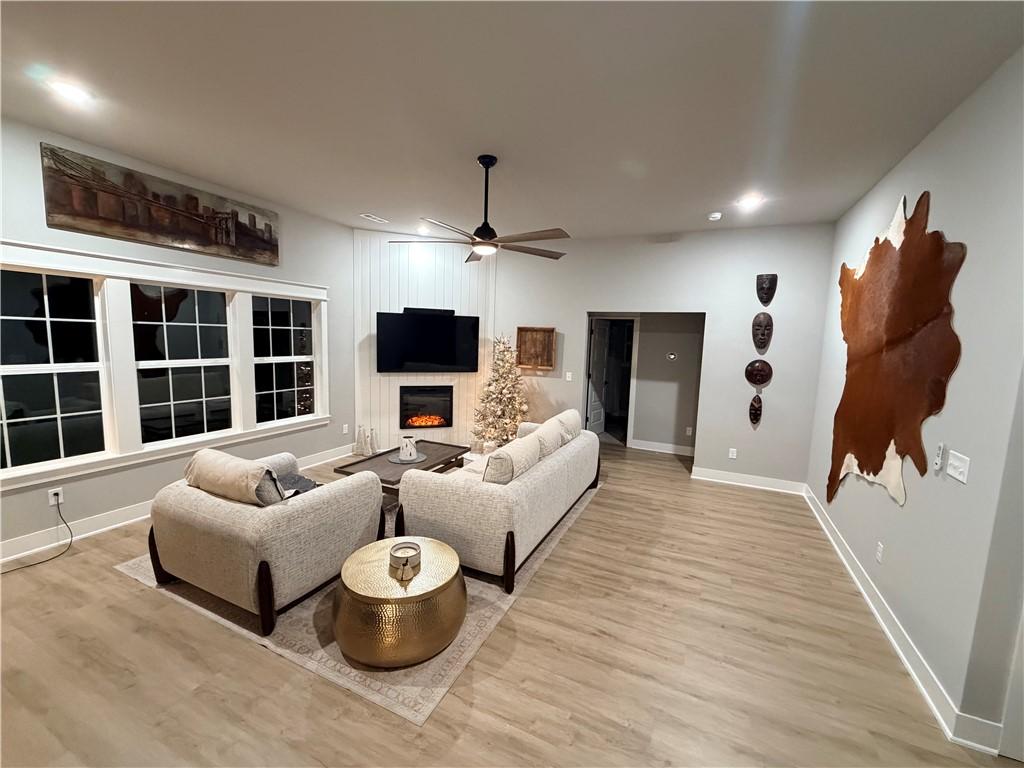 Image 4: Living area featuring a fireplace, recessed lighti