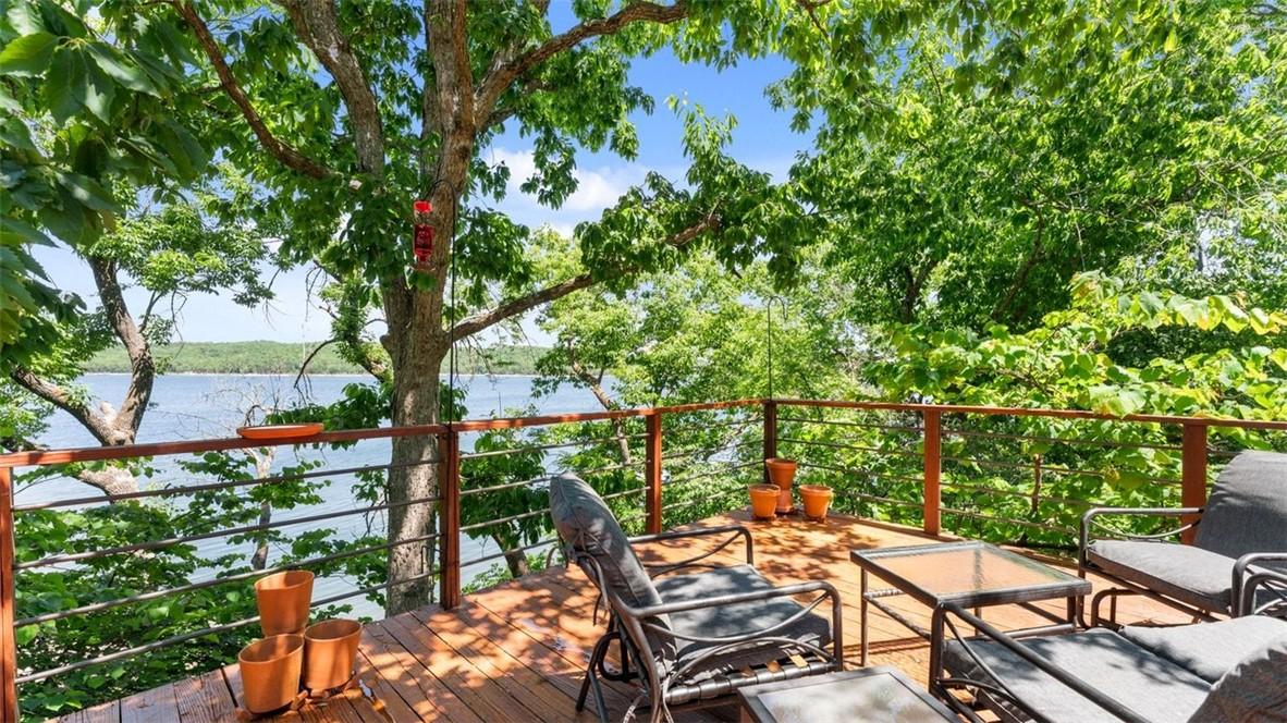 Image 2: Expansive outdoor deck featuring wood-finish floor