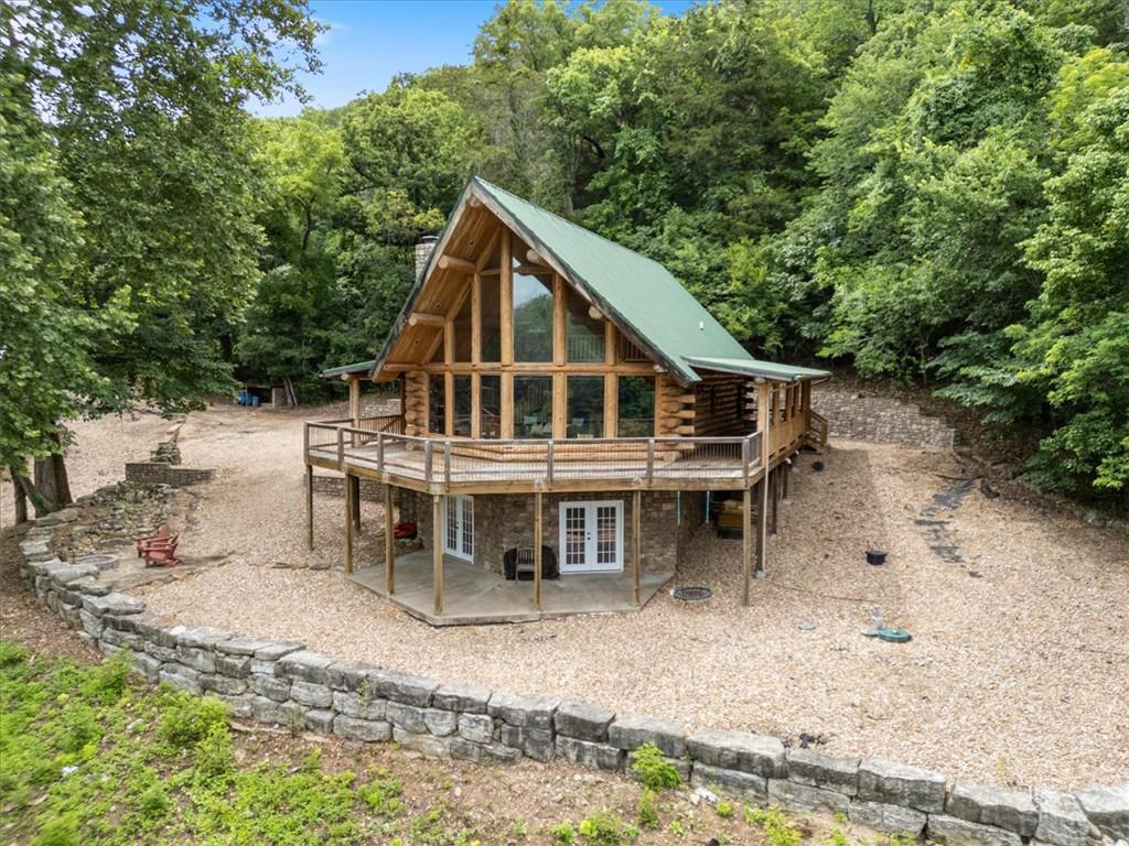 Image 4: Rustic log cabin featuring a prominent A-frame fac