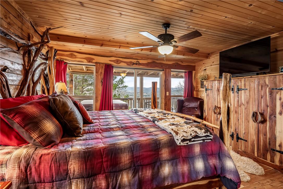 Image 3: Bedroom with wooden walls, access to outside, wood