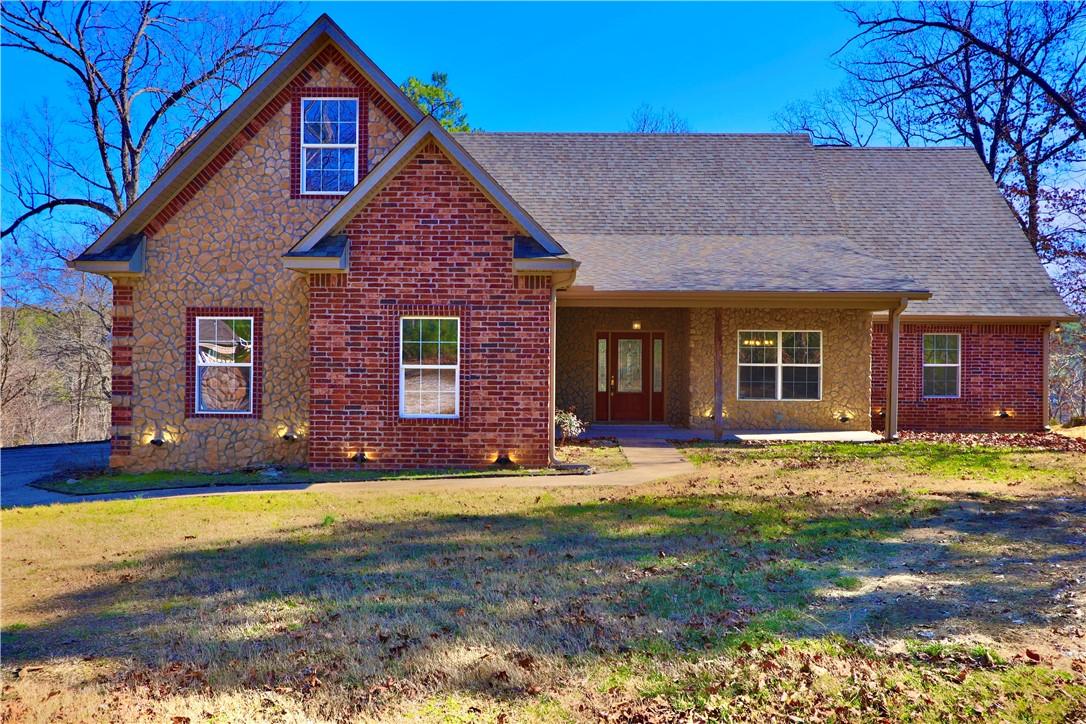 Image 1: Traditional home featuring covered porch, a front