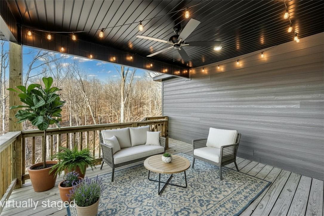 Image 3: Covered outdoor deck with wood-finish flooring and