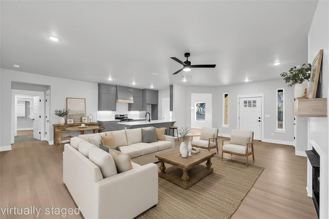 Image 4: Open-concept living area featuring wood-finish flo