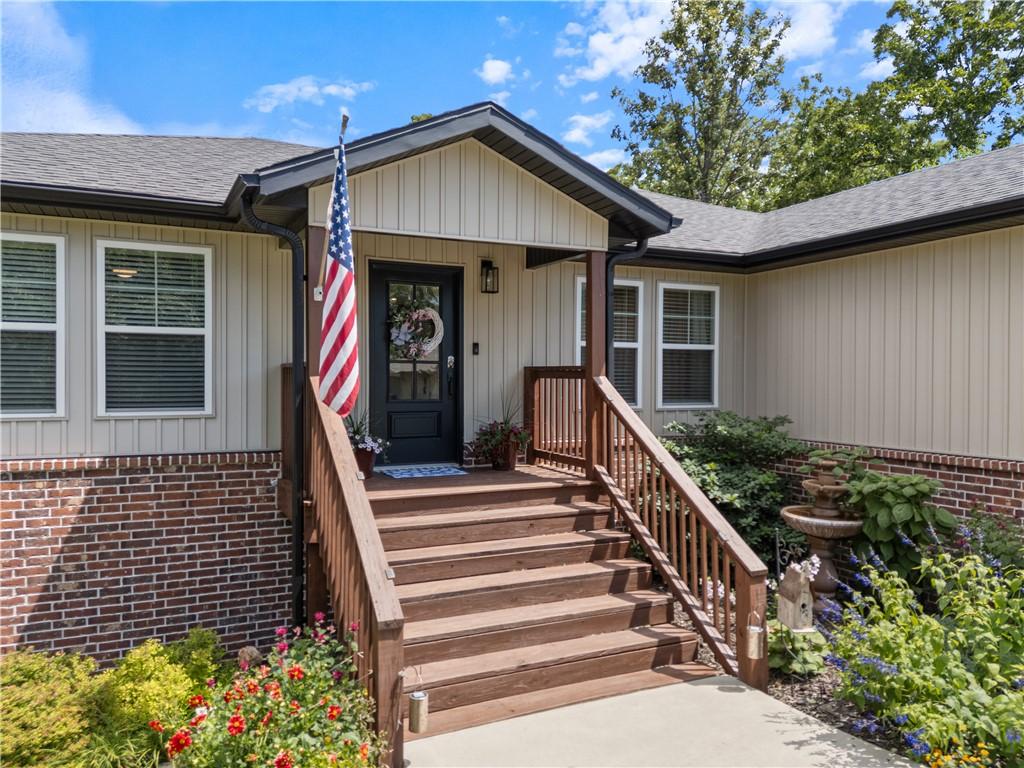 Image 3: Inviting front porch with wood-finish steps and ra