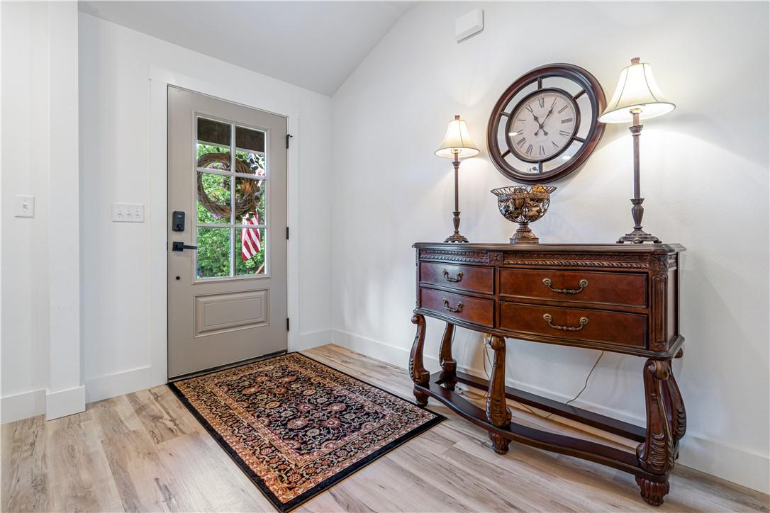 Image 4: Entryway featuring wood-finish flooring, a contemp