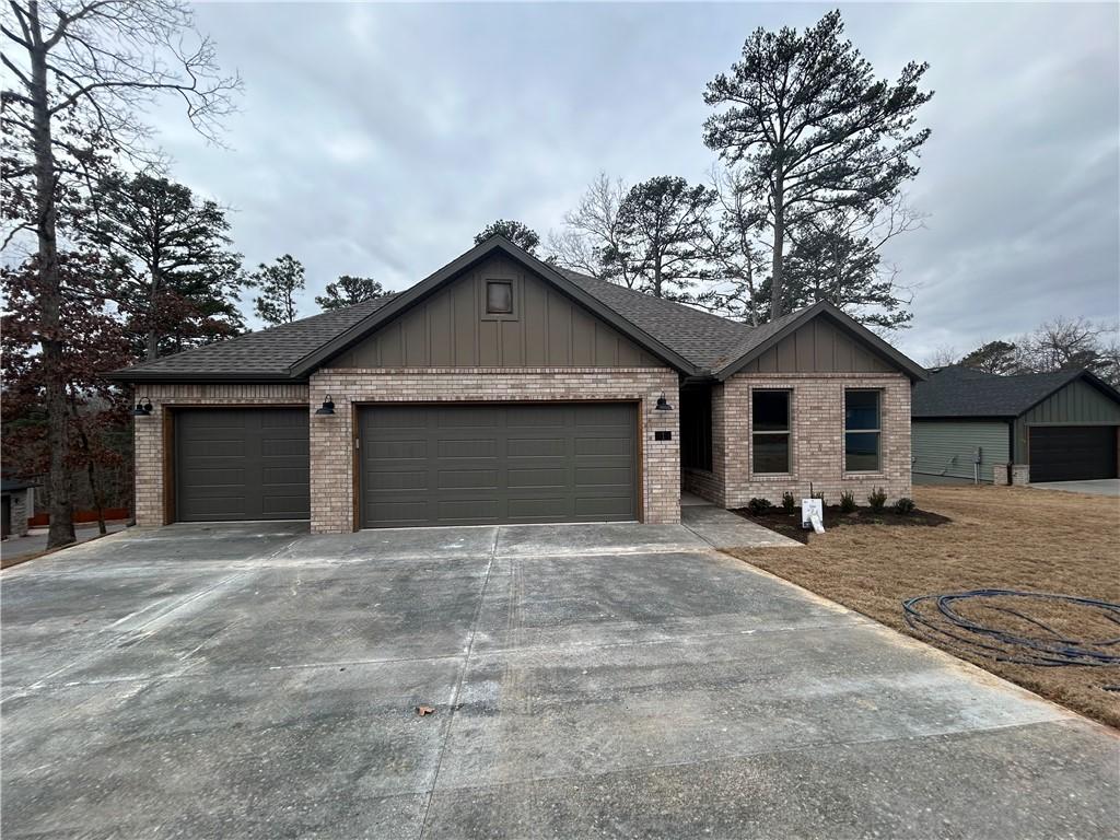 Image 2: Single story home with brick siding, board and bat