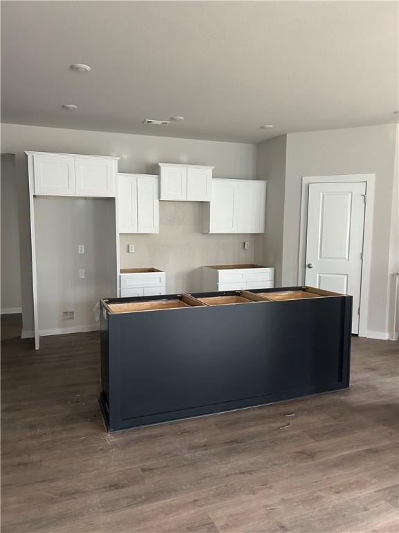 Image 4: Kitchen featuring white cabinets, a kitchen island