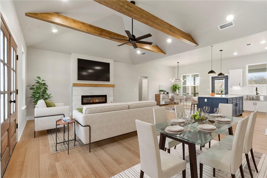 Image 4: Dining room with light wood-style floors, a glass