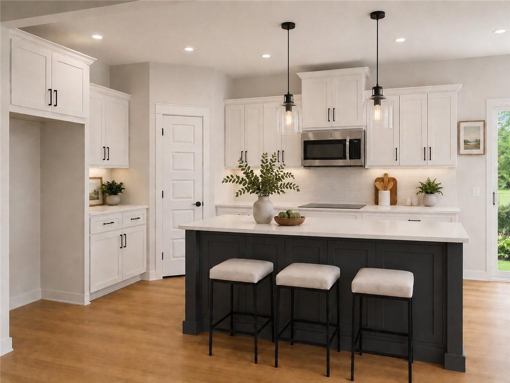 Image 2: Contemporary kitchen featuring a dark-toned island