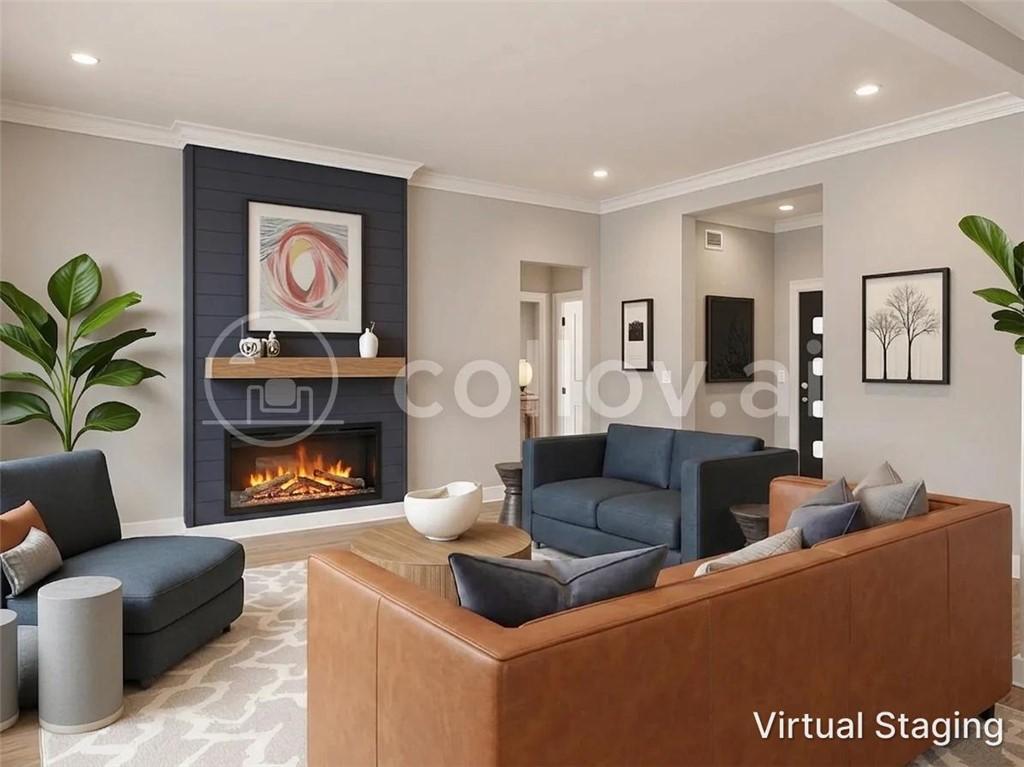 Image 4: Living area featuring an integrated fireplace, shi