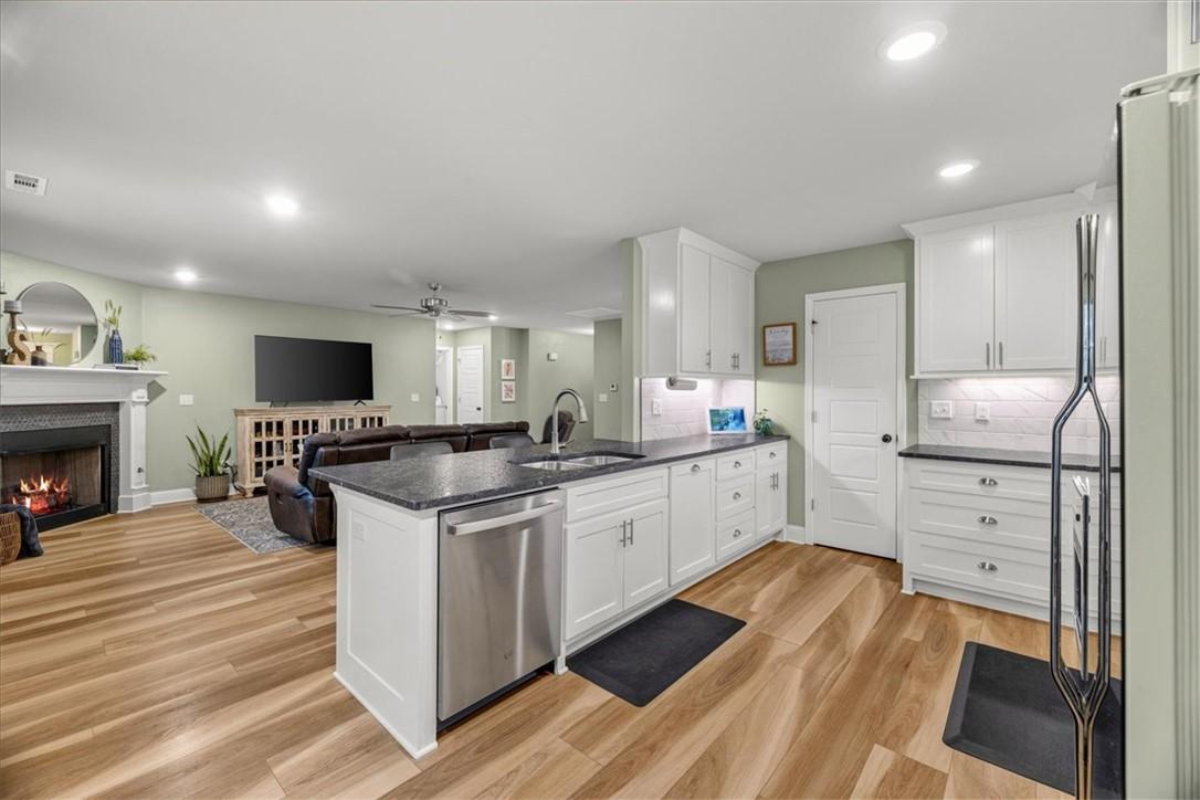 Image 3: Open-concept living area featuring wood-finish flo