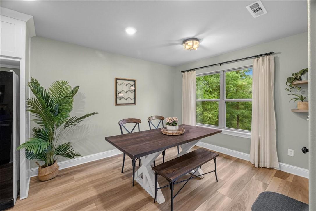 Image 4: Dining area featuring wood-finish flooring, a larg
