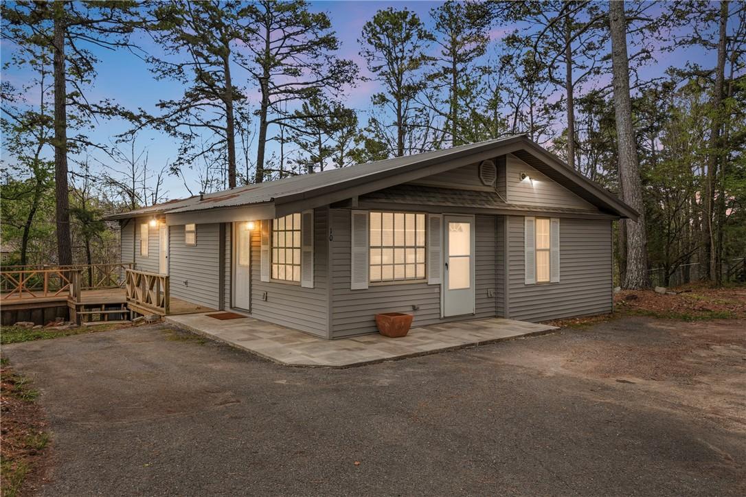 Image 1: View of front of property with a patio area and a