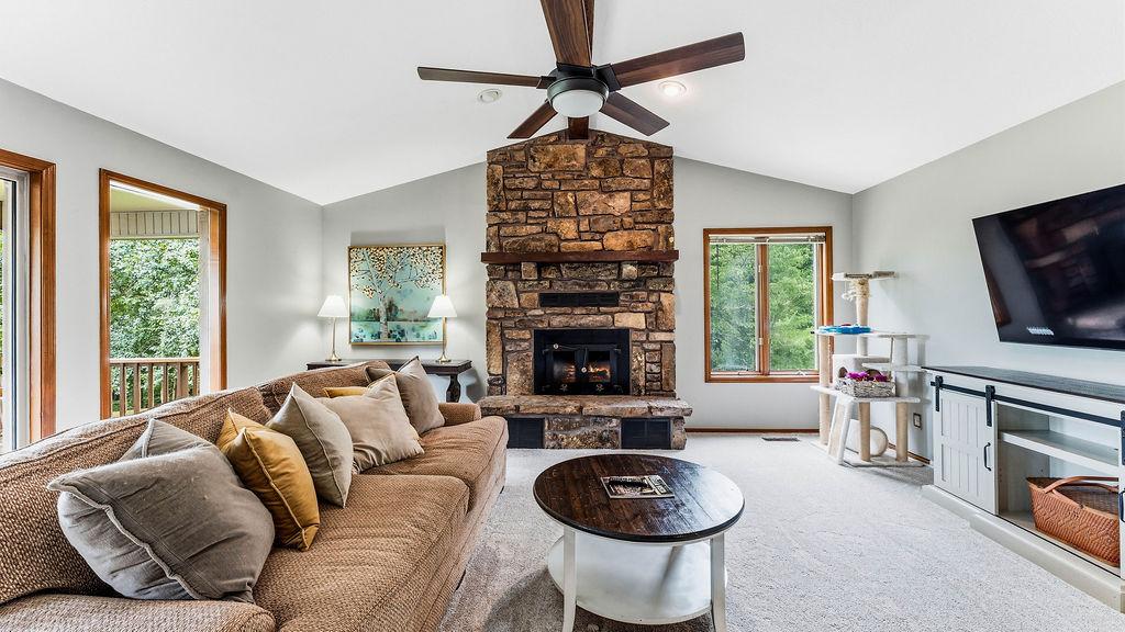 Image 4: Vaulted ceiling living area featuring a stone fire