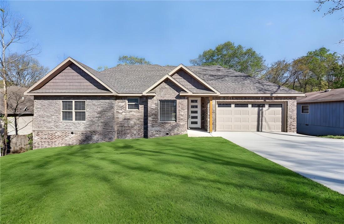 Image 1: Craftsman-style house with an attached garage, dri