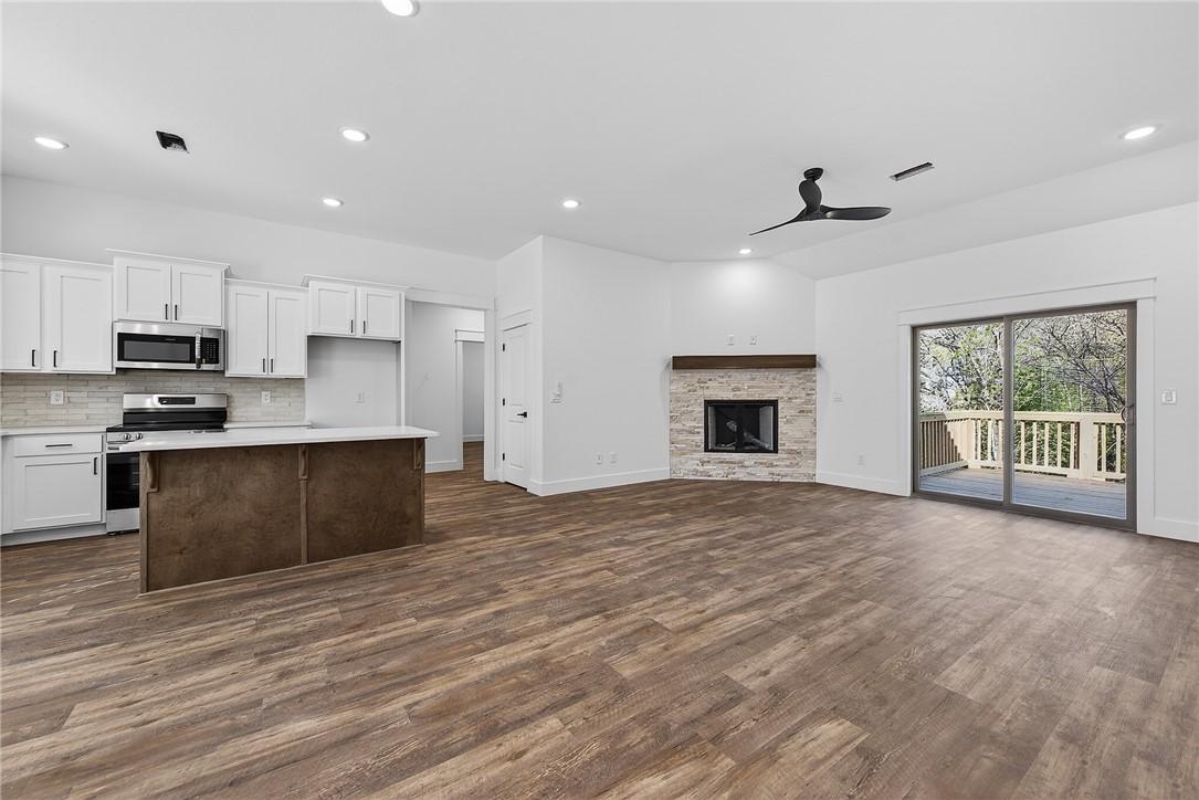 Image 2: Kitchen featuring white cabinetry, open floor plan