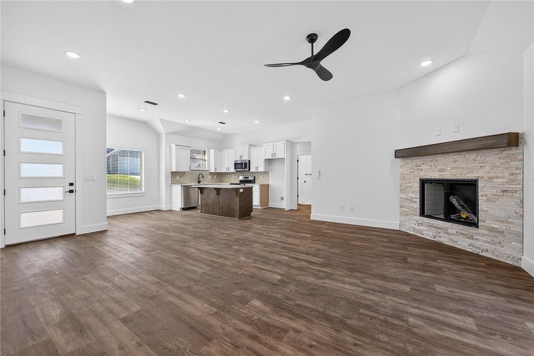 Image 4: Unfurnished living room with ceiling fan, a firepl