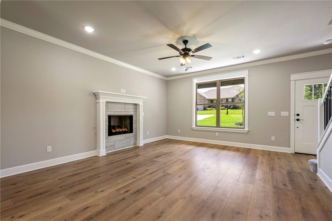 Image 2: Spacious living area featuring wood-finish floorin