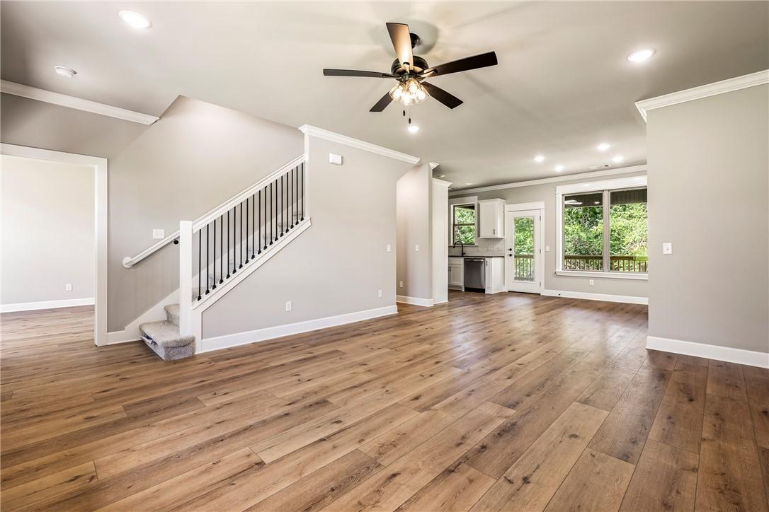 Image 4: Open-concept living area featuring wood-finish flo