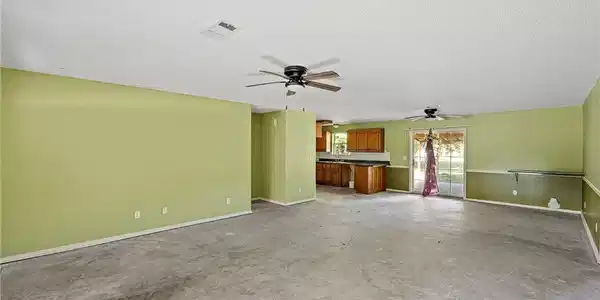 Image 3: Open-concept living area featuring a neutral ceili