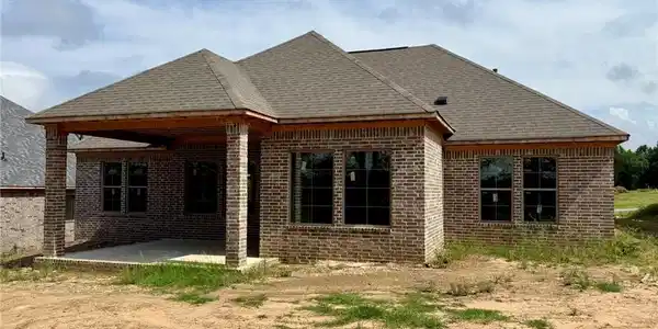 Image 3: Brick exterior featuring a covered patio, multiple