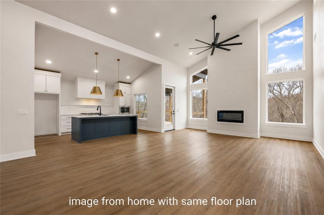 Image 3: Open-concept living area with vaulted ceilings and