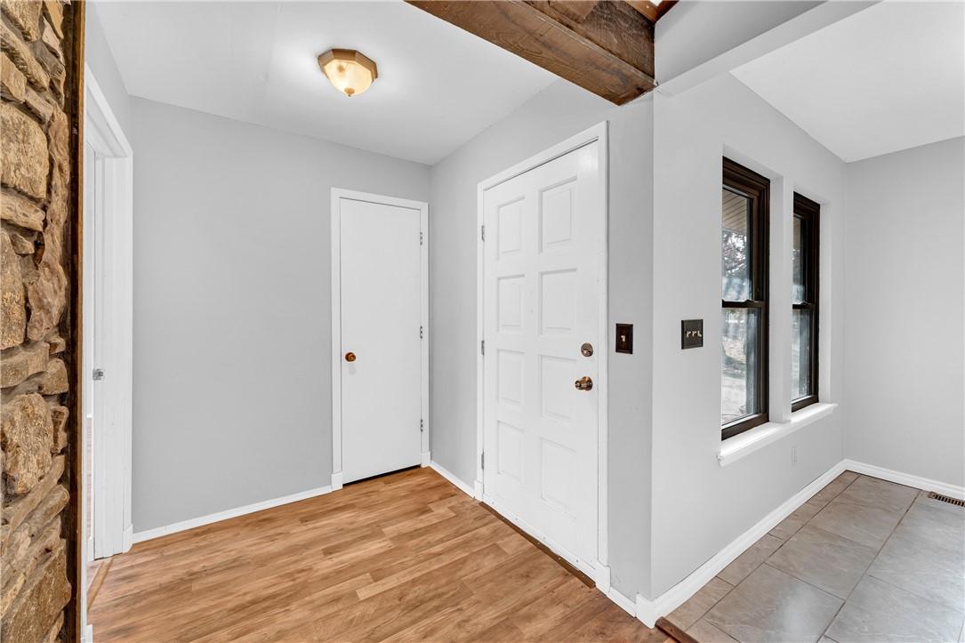 Image 3: Foyer with baseboards and light wood finished floo