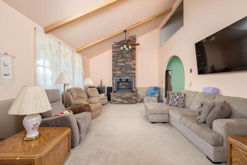 Image 1: Nice open living area with a wood stove.