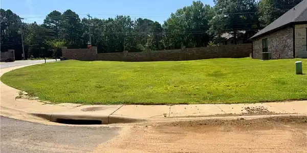 Image 4: Expansive cleared lot with a level grade, featurin