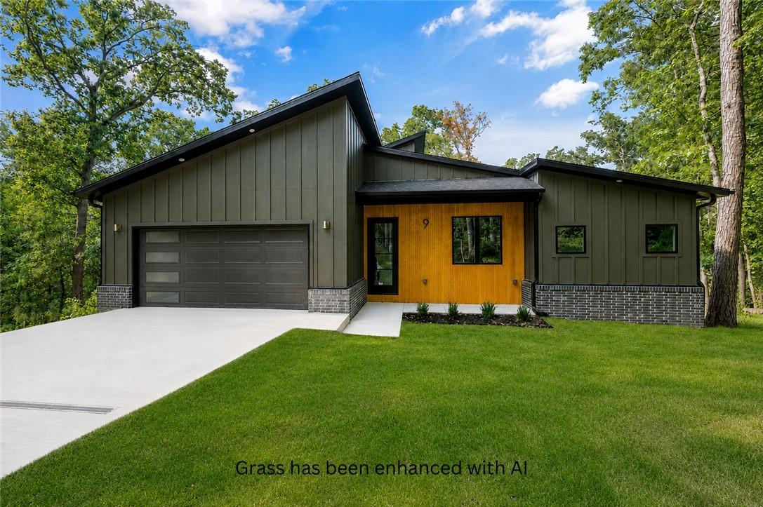 Image 1: Contemporary exterior with a dark green vertical p
