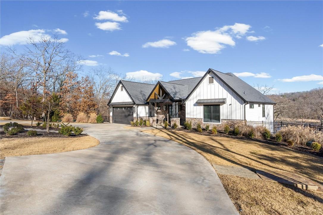 Image 2: View of front of property featuring stone siding,