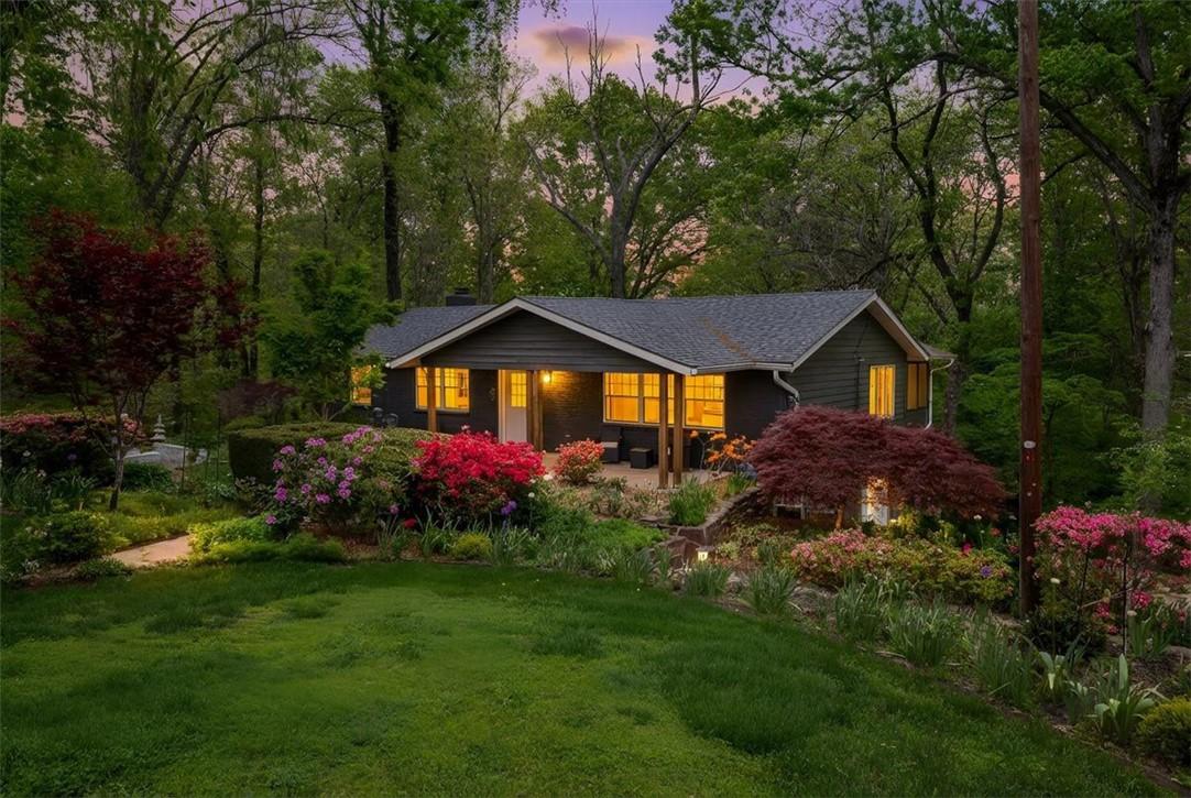 Image 1: The property features a dark-colored exterior, a g