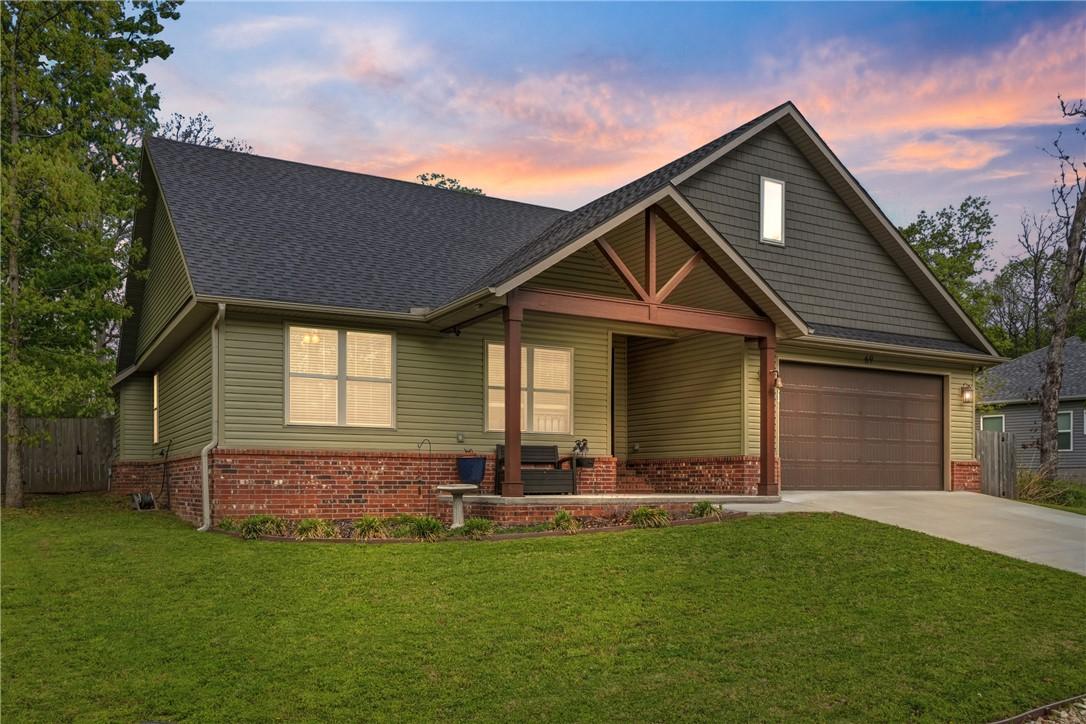 Image 2: The property features a well-maintained lawn, a co