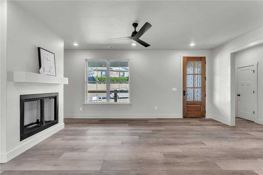 Image 3: Open-concept living space with wood-finish floorin