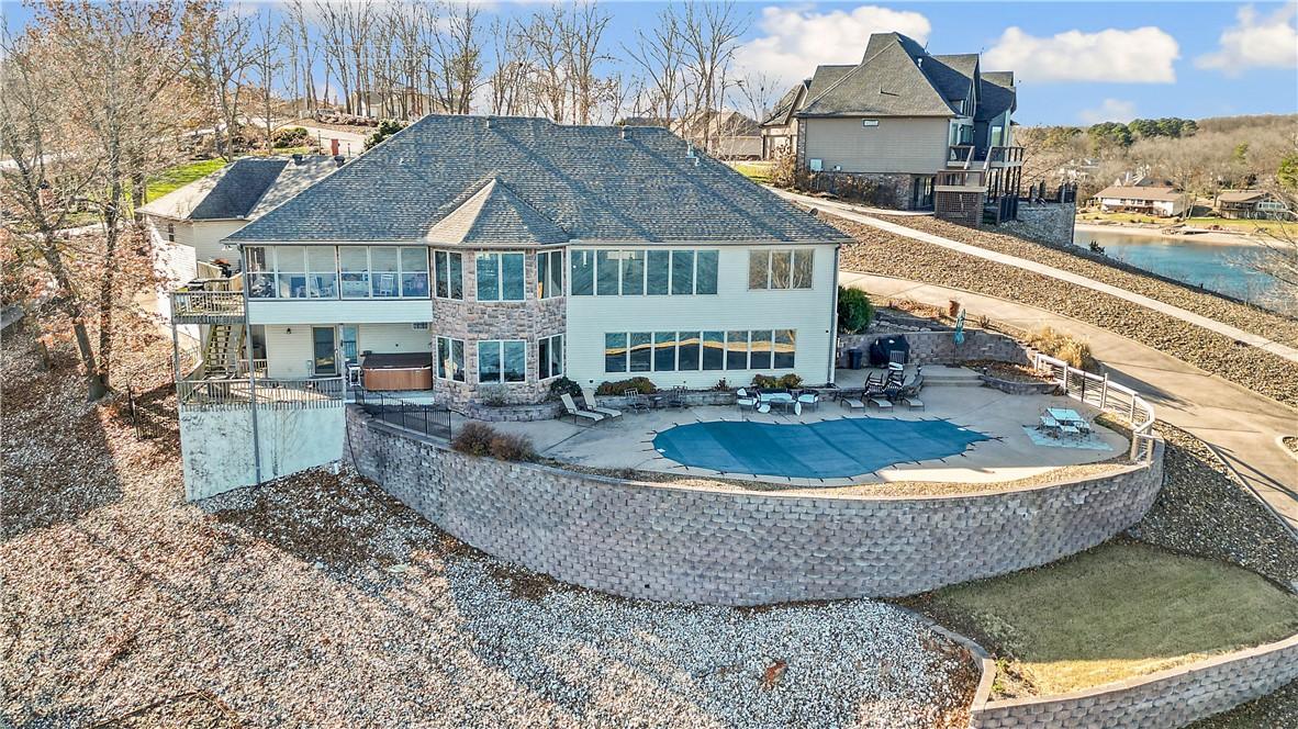 Image 2: Back of house with a patio, a covered pool, a balc