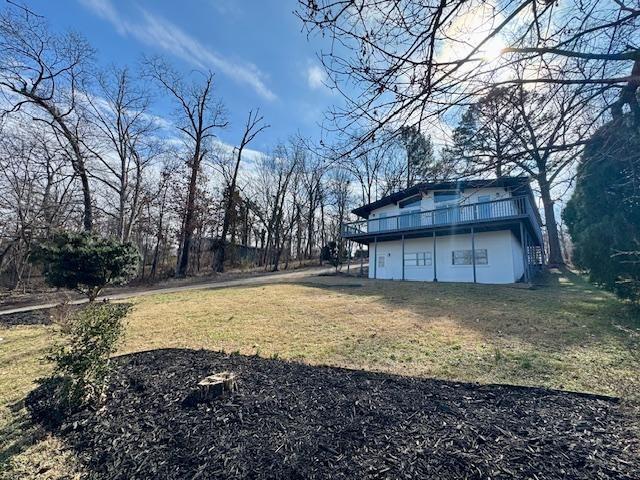 Image 4: View of grassy yard with a deck