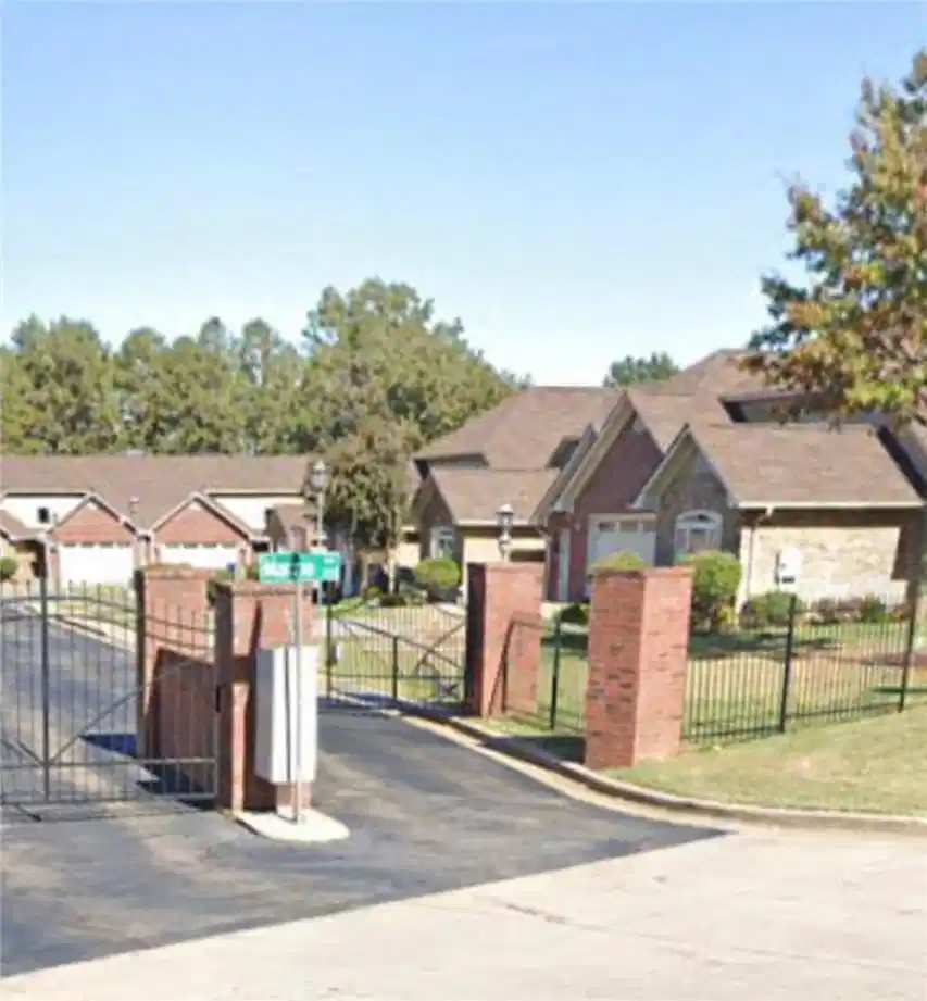Image 1: View of asphalt road with a gate, a gated entry, a