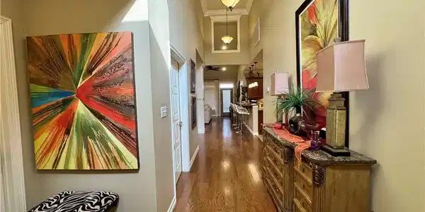 Image 2: Hallway featuring crown molding, dark wood finishe