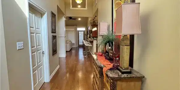 Image 3: Corridor featuring crown molding, dark wood-type f