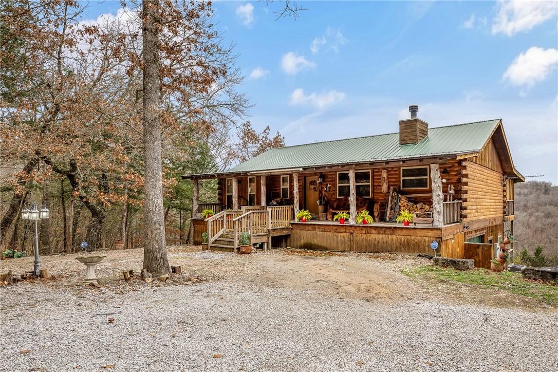 Image 1: View of front of property featuring log siding, a