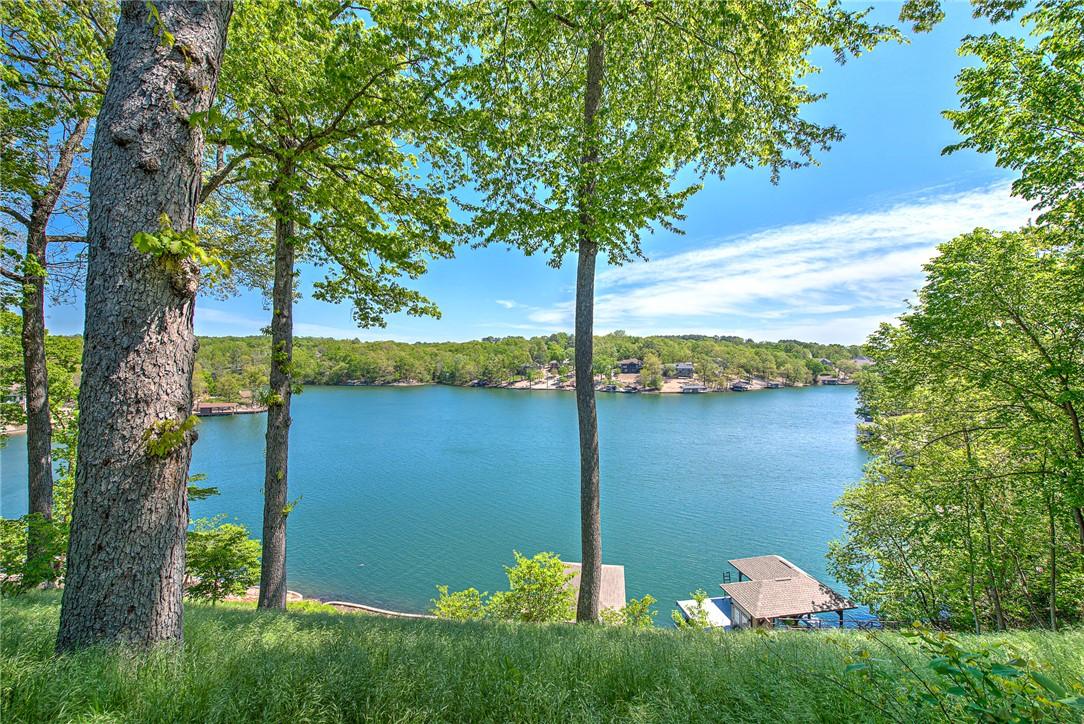 Image 1: Expansive lakefront property featuring a private d