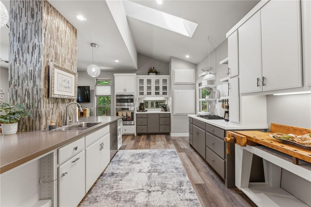 Image 3: Modern kitchen featuring vaulted ceilings with a s