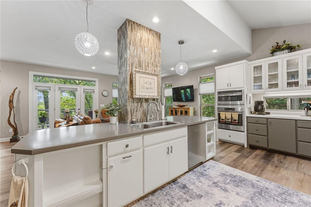 Image 4: Modern kitchen featuring a large island with an un