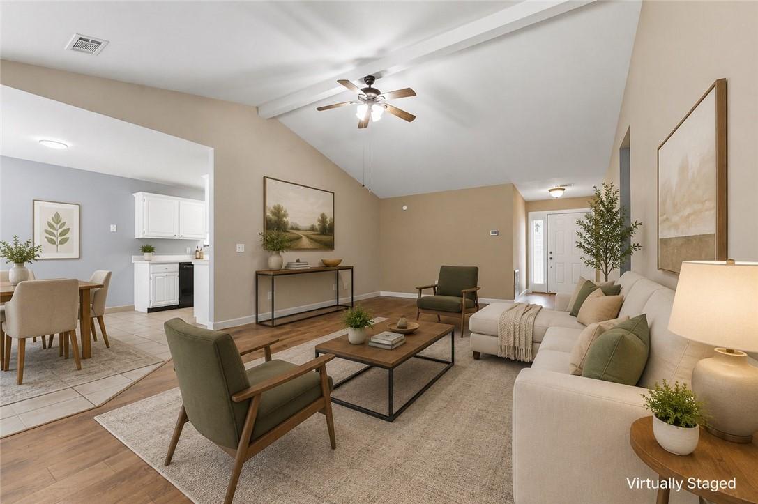 Image 2: Expansive living area featuring vaulted ceilings w