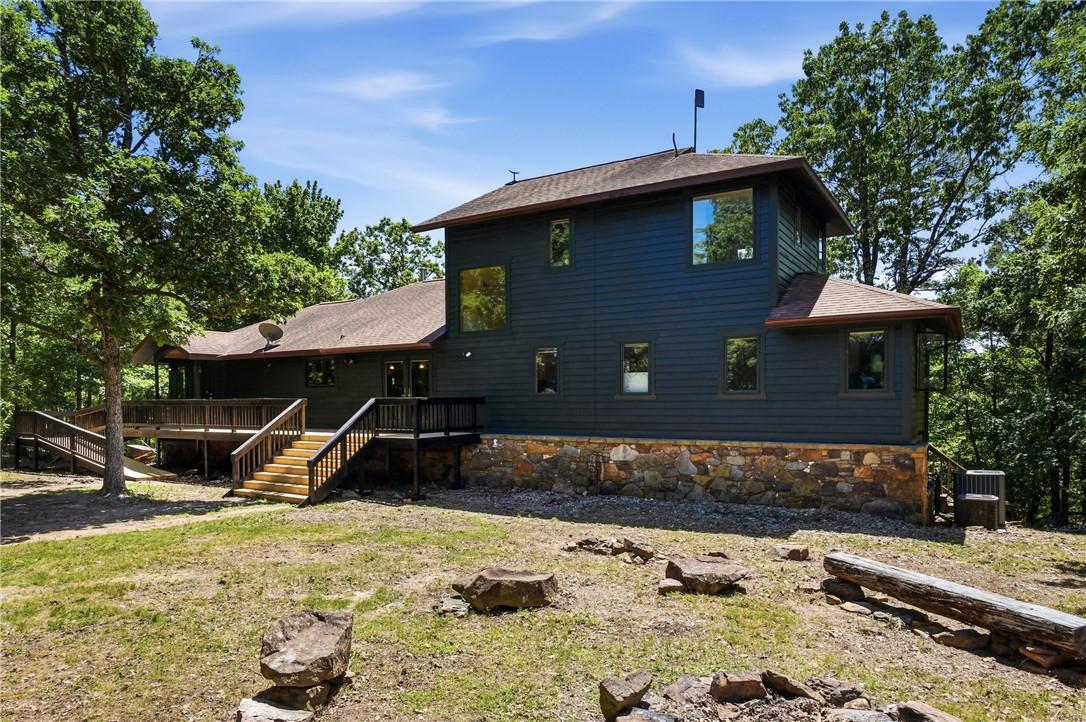 Image 1: Multi-level exterior featuring dark siding and a s